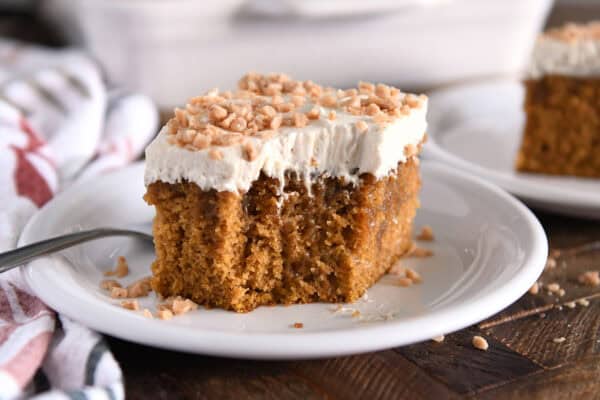 Pumpkin caramel cake square, take a bite and top with frosting and toffee.