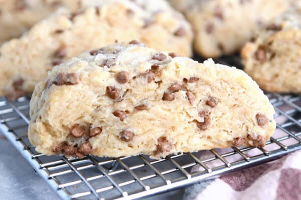 Side view of barbecue cinnamon slices on wire cooling rack with more scones behind.