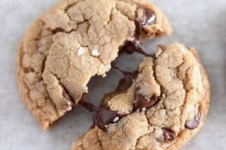 Top down view of a chocolate chip cookie halved with melting chocolate chips.