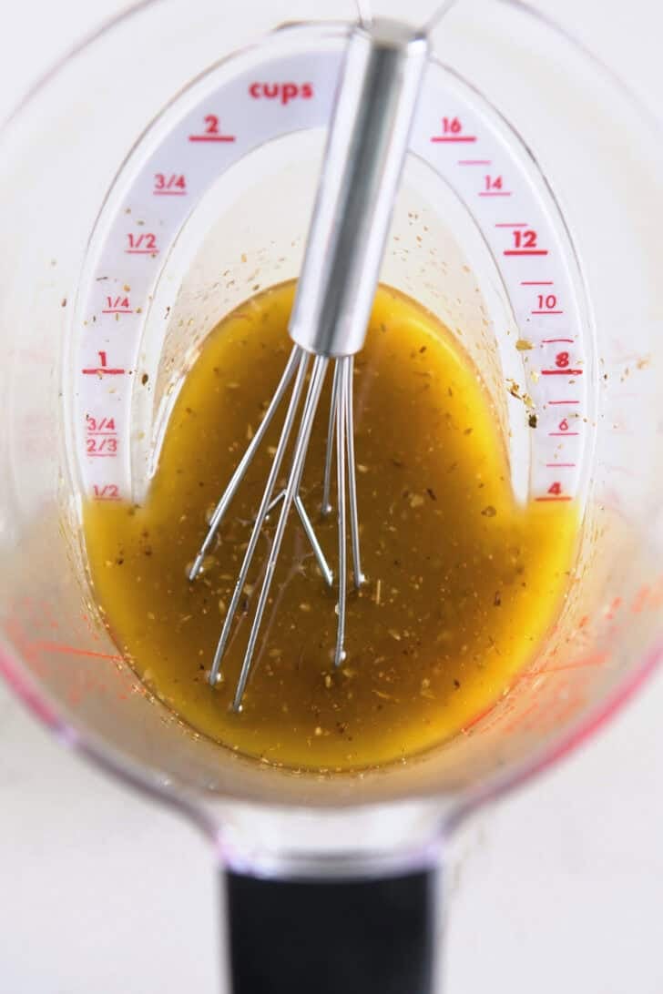 Use olive oil, lemon juice, oregano and garlic to make a liquid measuring cup.