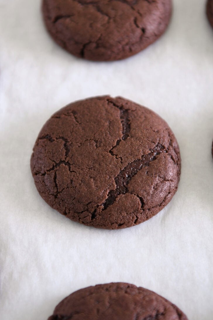 Chocolate chip cookies baked on parchment.