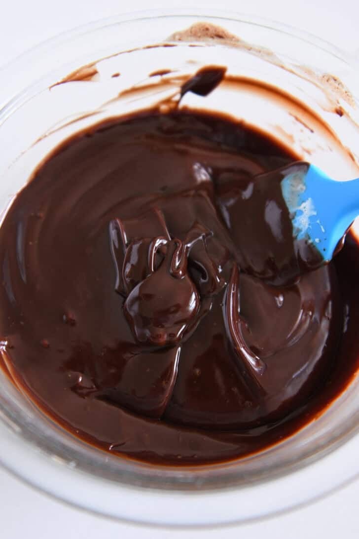 The glass bowl is from the top corner, filled with chocolate ganache.