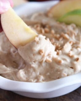 Dipping apple in toffee apple dip.