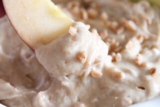 Dipping apple in toffee apple dip.