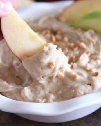 Dipping apple in toffee apple dip.