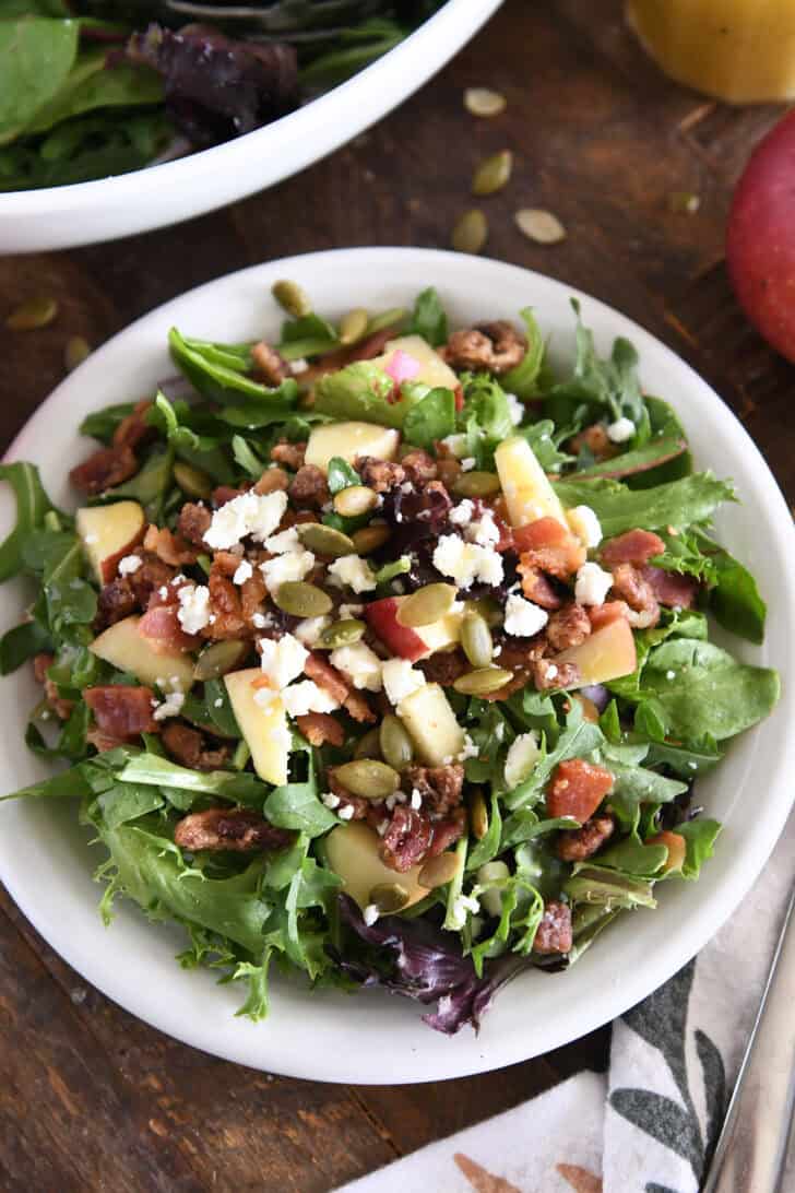 The highest green screen views on a white pulp seed with fried pumpkin, apples, chopped pecans, feta cheese and red onions.