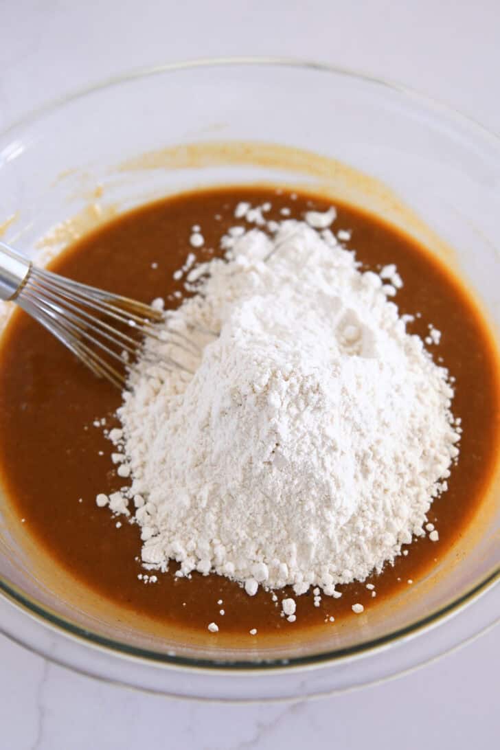 In a glass bowl, mix the Pumpkin Cupcake Batter and flour with a wire whisk.