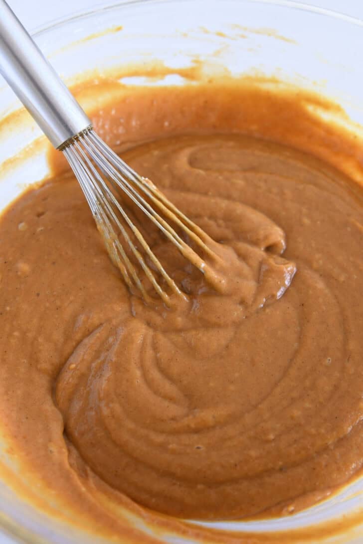 Whisk the cupcake batter in a glass bowl with a wire whisk.