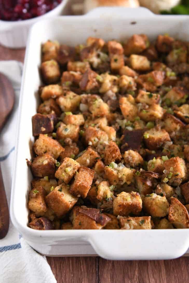 White 9X13-inch pan with baked sausage and herb stuffing.