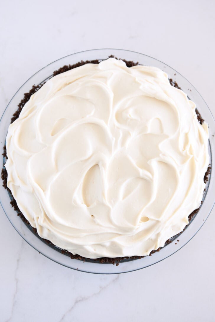 Whipped cream mixture dolloped and spread across top of pie.