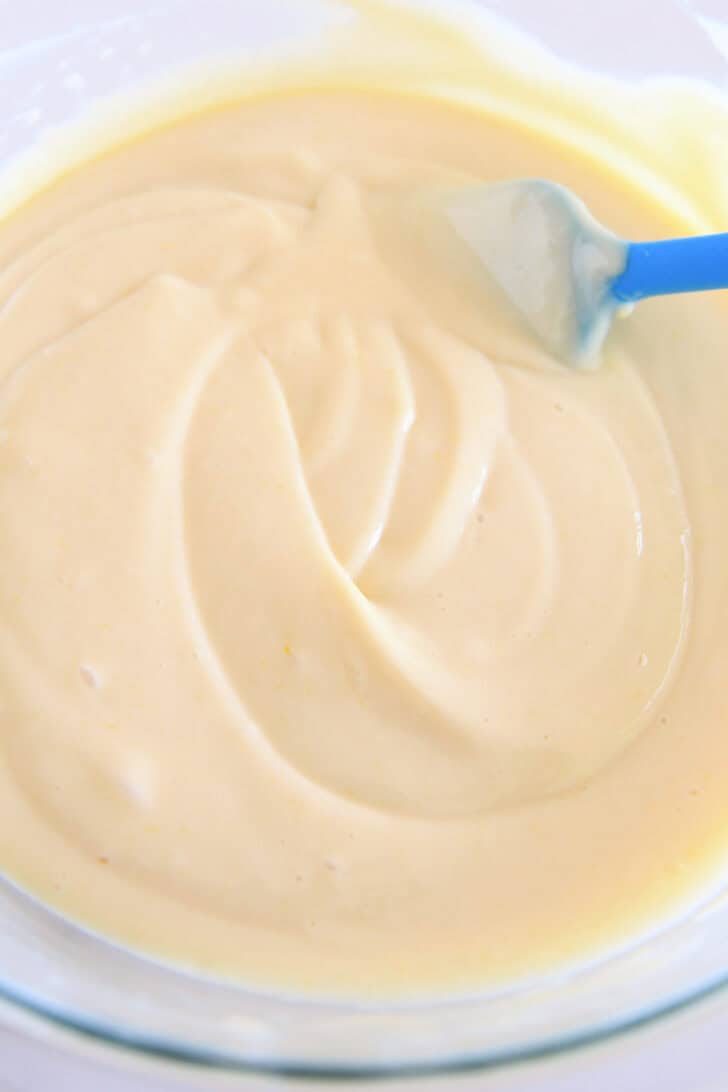 Top down view of a glass bowl with a creamy lemon pie filling.