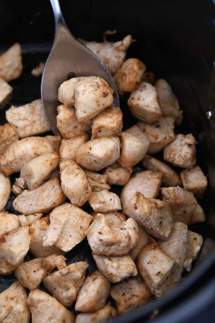 Cooked chicken pieces in air fryer.