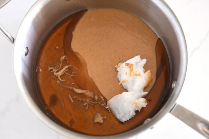 Saucepan with peanut butter, coconut oil, maple syrup and honey.