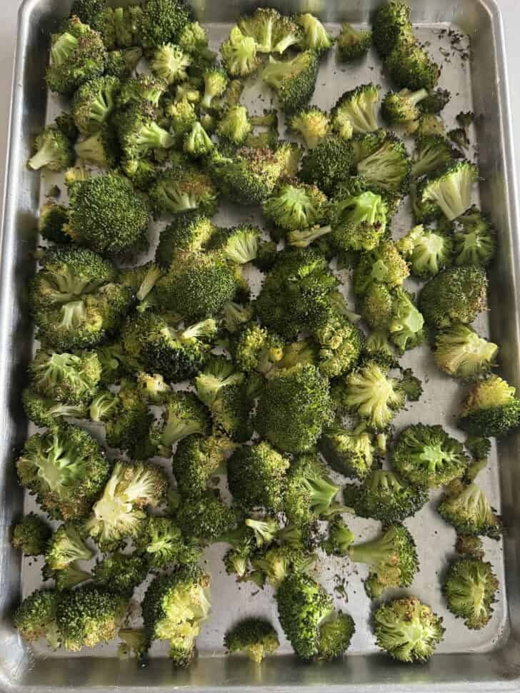 Sheet pan with roasted broccoli.
