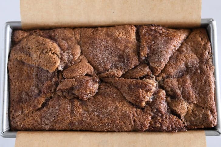 Loaf pan with toasted cinnamon swirl bread.