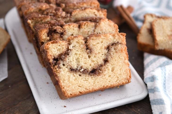 Three slices of cinnamon swirl quick bread on a white tray.