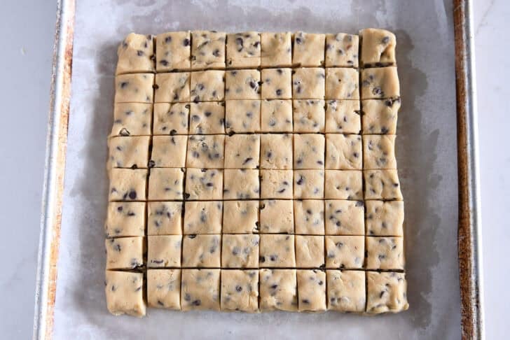 Press cookie dough into squares and cut into 64 mini squares.