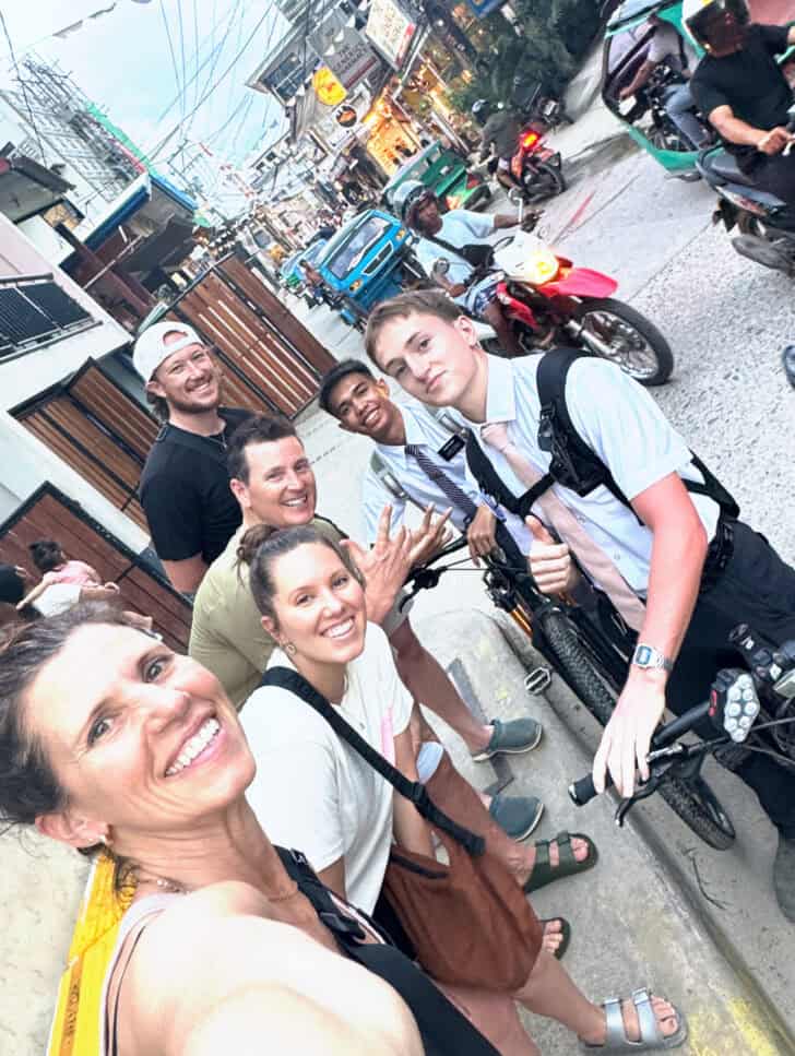 Picture of two missionaries on bikes with family.