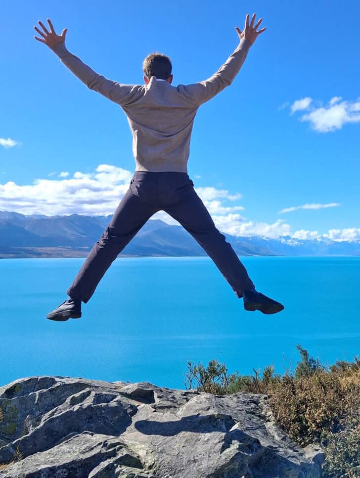 Kid jumping off rock.