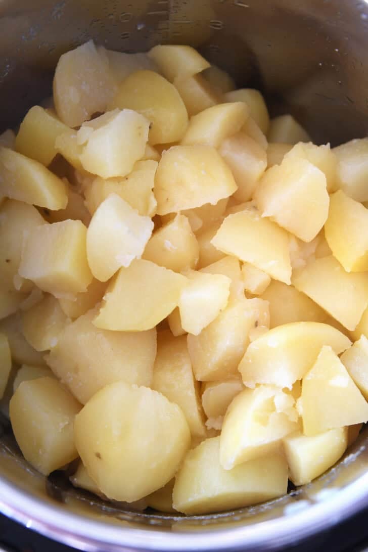 Top down view of an Instant Pot with cooked chunks of potato.