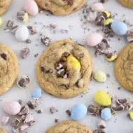 Cookies sprinkled with whole crushed Cadbury eggs and baked on parchment paper.