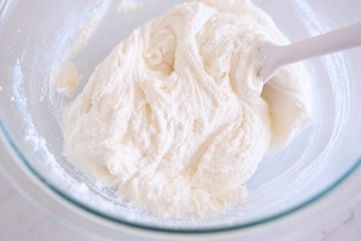 Glass bowl with creamed sugar, oil and butter.