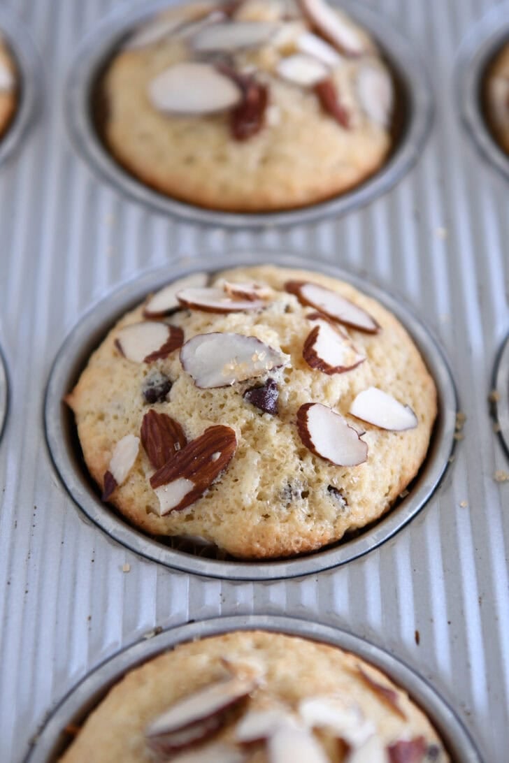Almond coconut chocolate chip muffins baked in a muffin tin.