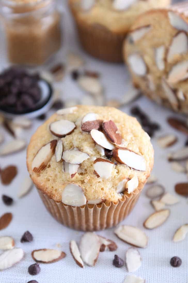 Almond coconut chocolate chip muffins in brown paper muffin liners.