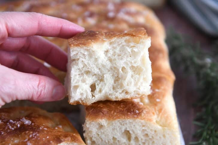 Top the toasted focaccia loaf with half a slice of fluffy focaccia bread.