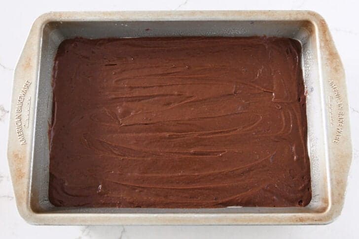 Metal 9X13-inch pan with brownie batter.