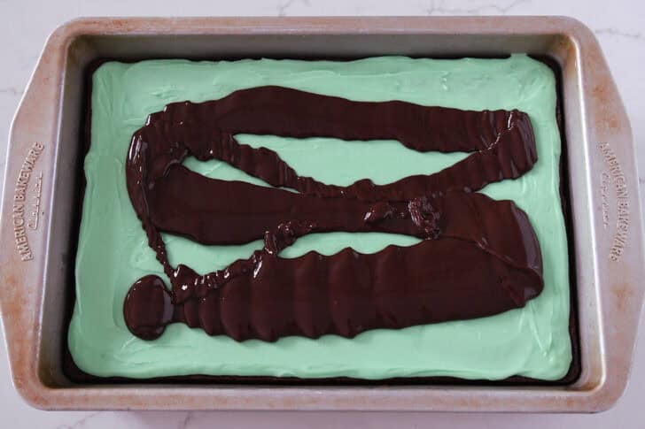 Metal 9X13-inch pan with brownies, mint frosting, and chocolate ganache.