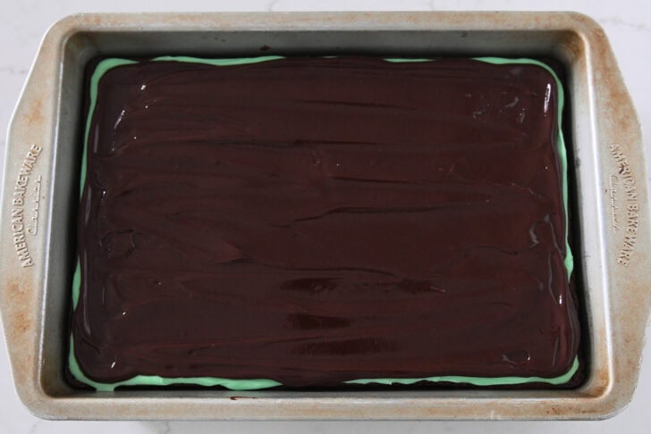 Metal 9X13-inch pan with brownies, mint frosting, and chocolate ganache.