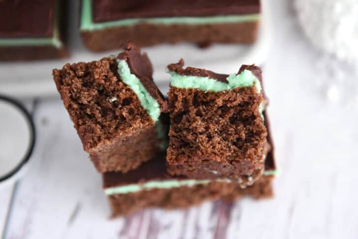 Two half pieces of chocolate mint brownies.