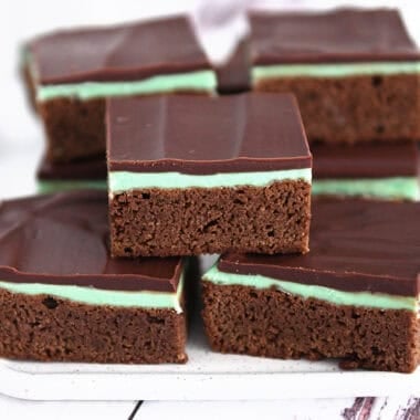 White tray of squares of chocolate mint brownies.