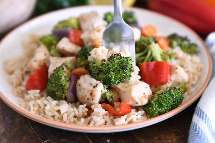 You eat cooked chicken, brown rice, and broccoli by scooping them up with a fork.