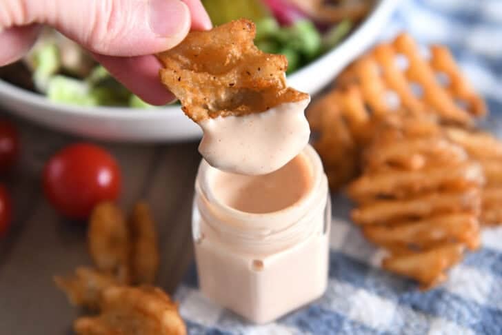 Eat fried sweet potato waffles dipped in cream sauce.