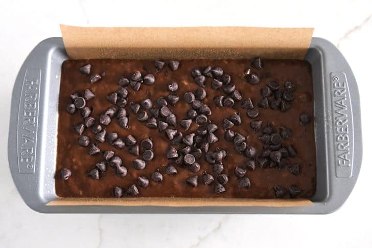 Top down view of a loaf of unbaked chocolate banana bread.