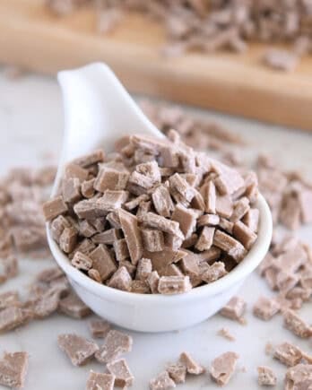 White bowl with chopped cinnamon bits for baking.