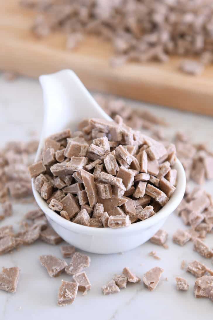 White bowl with chopped cinnamon bits for baking.