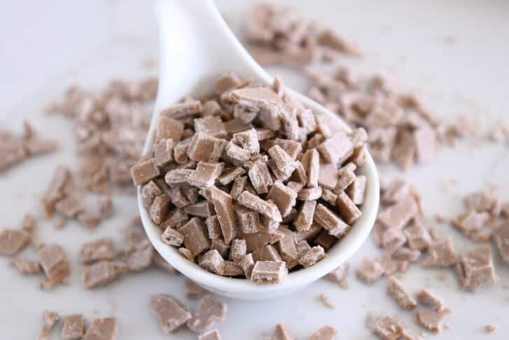 White bowl with chopped cinnamon bits for baking.