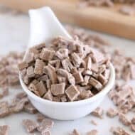 White bowl with chopped cinnamon bits for baking.