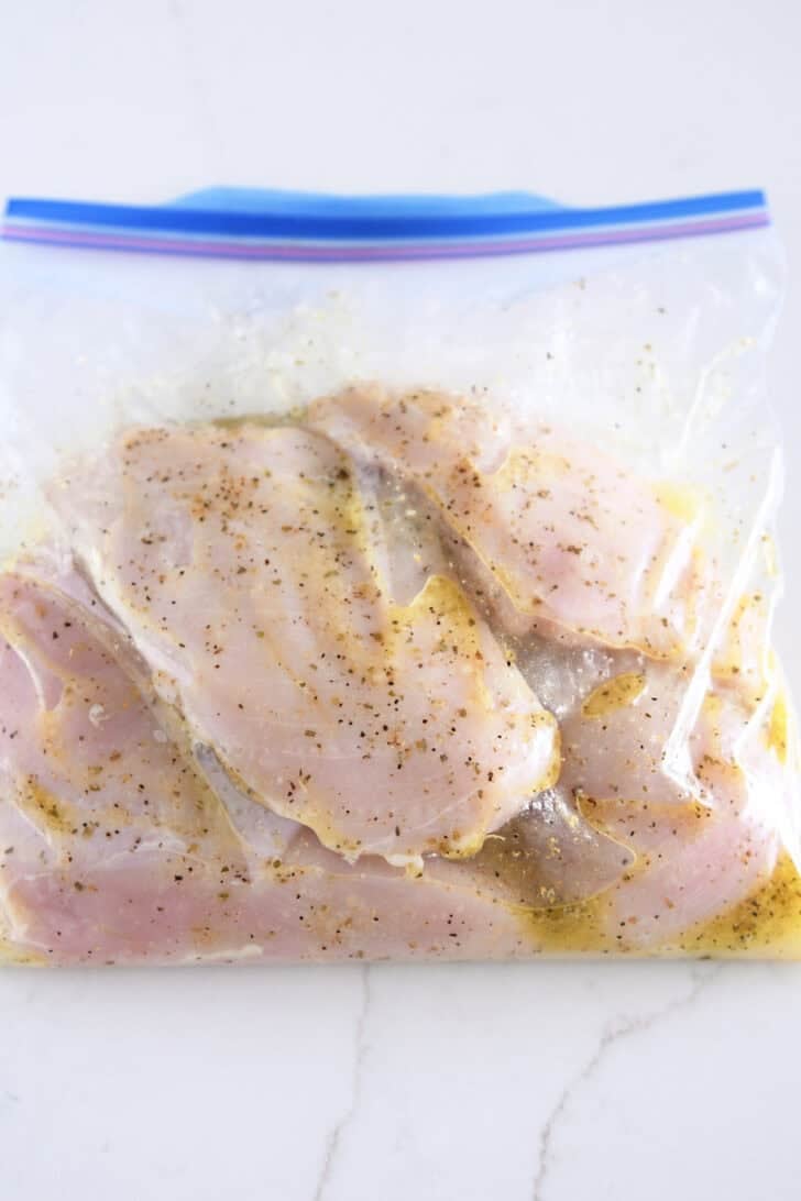 Chicken breasts marinading in ziploc bag.