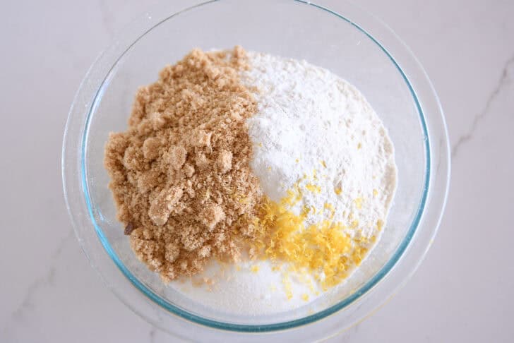 Glass bowl with brown sugar, flour, and lemon zest.