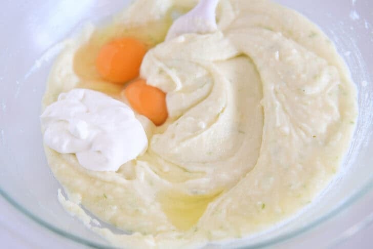 Mix butter, lime zest, sugar, eggs, oil and sour cream in a glass bowl.