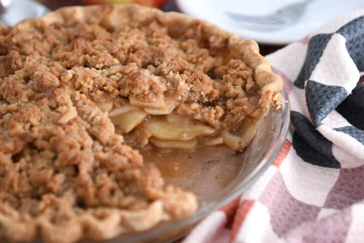 Apple crumble pie with slice removed.