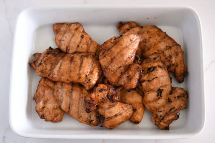 White pan with five or six pieces of grilled honey garlic chicken.