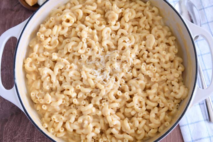 Top down view of creamy skillet macaroni and cheese in white cast iron skillet.