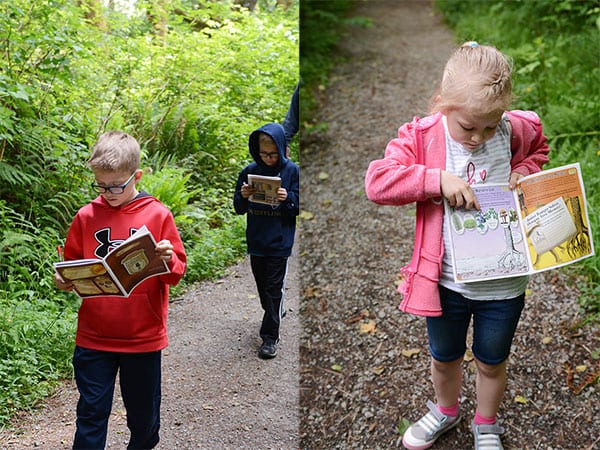 Kids looking down at Prairie Creek State Park Junior Ranger Booklets.