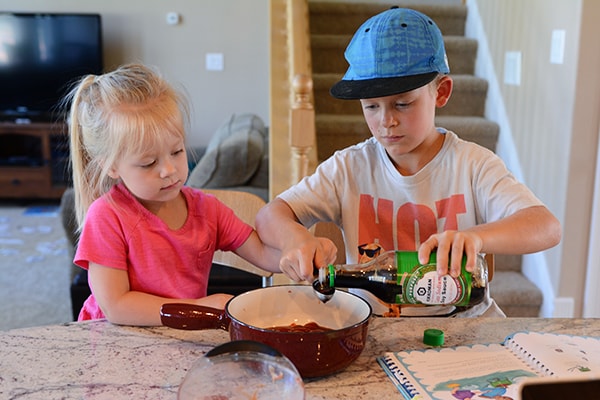 A little boy and girl cooking together.