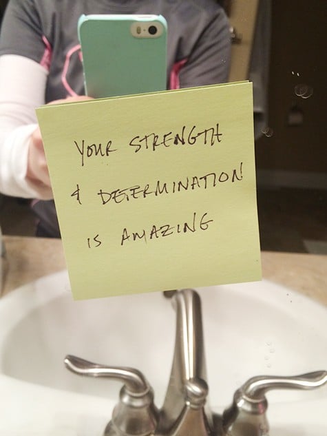 A sticky note on a mirror that says your strength and determination is amazing.